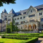 A historic stone imperial castle with a garden in Poznan