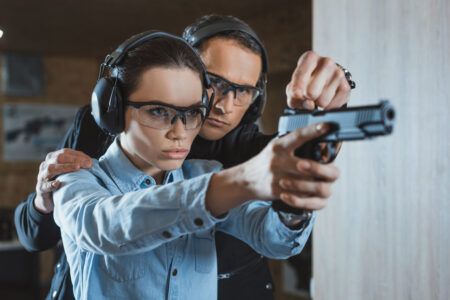 Instructor helping customer in shooting