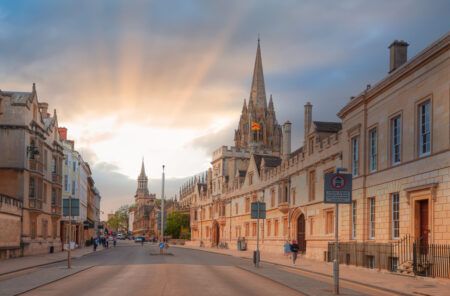 View of High Street road with Cityscape of Oxford at sunset