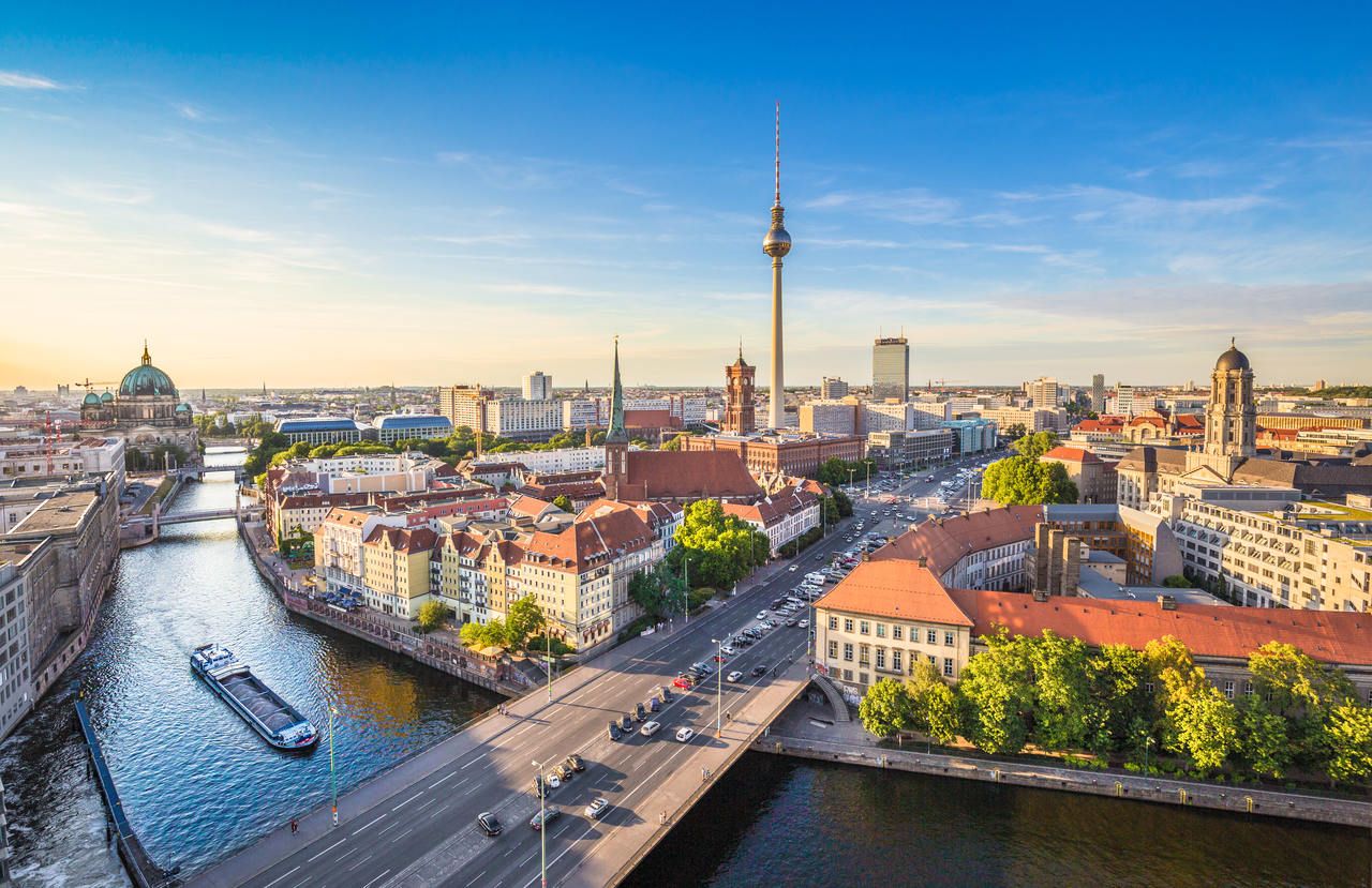 Aerial view of Berlin skyline with famous TV tower and Spree river in beautiful evening light at sunset in summer, Germany