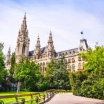 Facade of Vienna City Hall building, view from picturesque green park