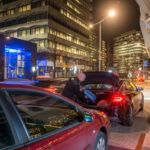 Taxi driver loading passenger luggage