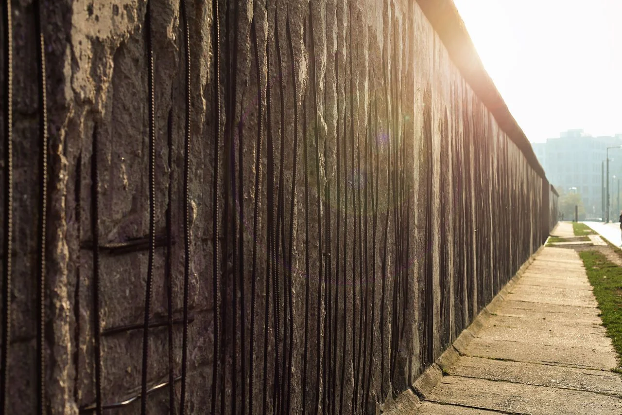 The Berlin Wall with a sun flare. The wall divided the city of Berlin into east and west from 1961 to 1989.