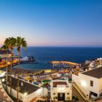 View over the resorts of Puerto Rico in Gran Canaria and the beach early in the morning at dawn