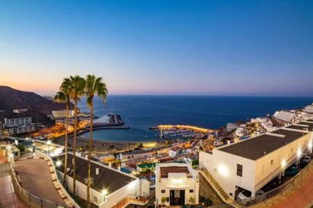 View over the resorts of Puerto Rico in Gran Canaria and the beach early in the morning at dawn
