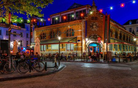 Old street with tables of cafe in center of Brussels, Belgium. Night cityscape of Brussels
