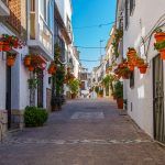 A typical street in old city Estepona with colorful flower pots