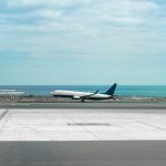 Airplane in airport runaway with sea on the background