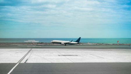 Airplane in airport runaway with sea on the background