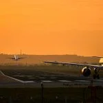 Airplanes take off at sunset at the airport of sevilla