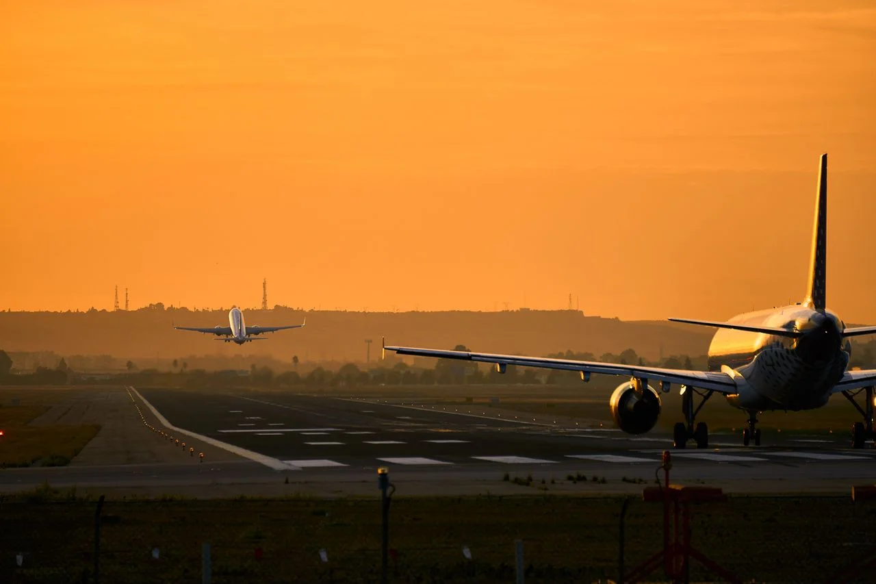 Airplanes take off at sunset at the airport of sevilla