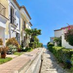 Beautiful walk path by the sea between urbanisations in Estepona and Marbella on a sunny day with blue sky and palm trees