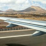 Takeoff at airport of Lanzarote with volcanoes at the horizon