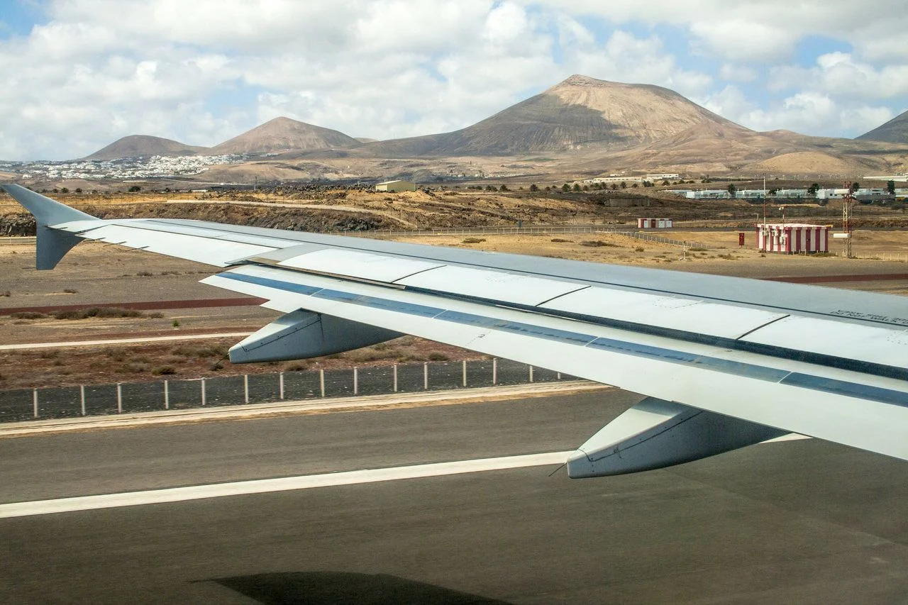 Takeoff at airport of Lanzarote with volcanoes at the horizon