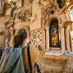 Young woman photographing the ornate Spanish architecture of Castillo de Colomares Benalmadena