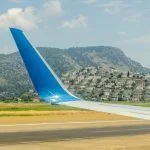 Aerial shooting from an airplane flying over the ground mountains in Dalaman Airport Turkey Mugla