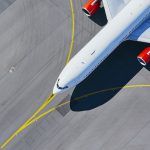 Aerial view of the airport. Airplane taxiing to the runway before take-off.