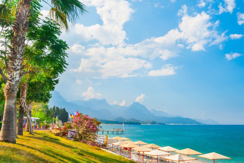 Beautiful beach with green trees in Kemer, Turkey. Summer landscape, travel and vacation