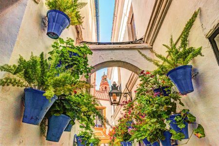 Beautiful white walls decorated with colorful flowers – Old European Town.