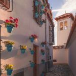 Early morning golden light over the quiet and quaint narrow cobblestone streets in old town (Albaicin or Arab Quarter) Granada