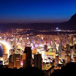 Panorama of the city and the sea coast at sunset on a background of mountains (Spain, Benidorm)