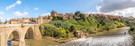 Panorama of the old historic city of Toledo with the Puente de San Martín bridge on the left and the Rio Tajo River on the front. Toledo, Spain