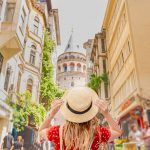 Portrait of a beautiful woman from behind overlooking the Galata tower in Beyoglu, Istanbul, Turkey