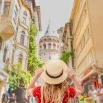 Portrait of a beautiful woman from behind overlooking the Galata tower in Beyoglu, Istanbul, Turkey