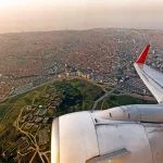 Scenic aircraft window seat aerial sunrise view of Istanbul city skyline with european part of city panoramic wide