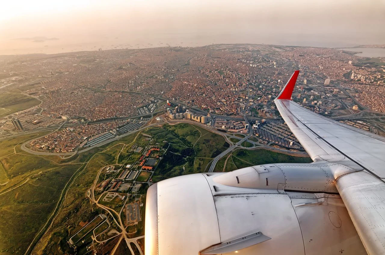 Scenic aircraft window seat aerial sunrise view of Istanbul city skyline with european part of city panoramic wide