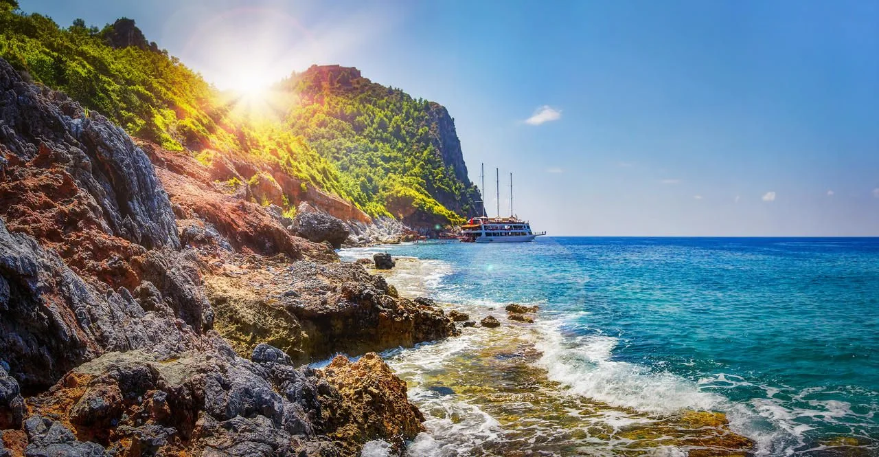 Tropical rocky beach on sunny summer day in Alanya, Turkey.