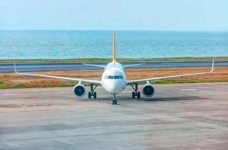 White passenger airplane taxiing on airport apron in the background amazin black sea – Trabzon