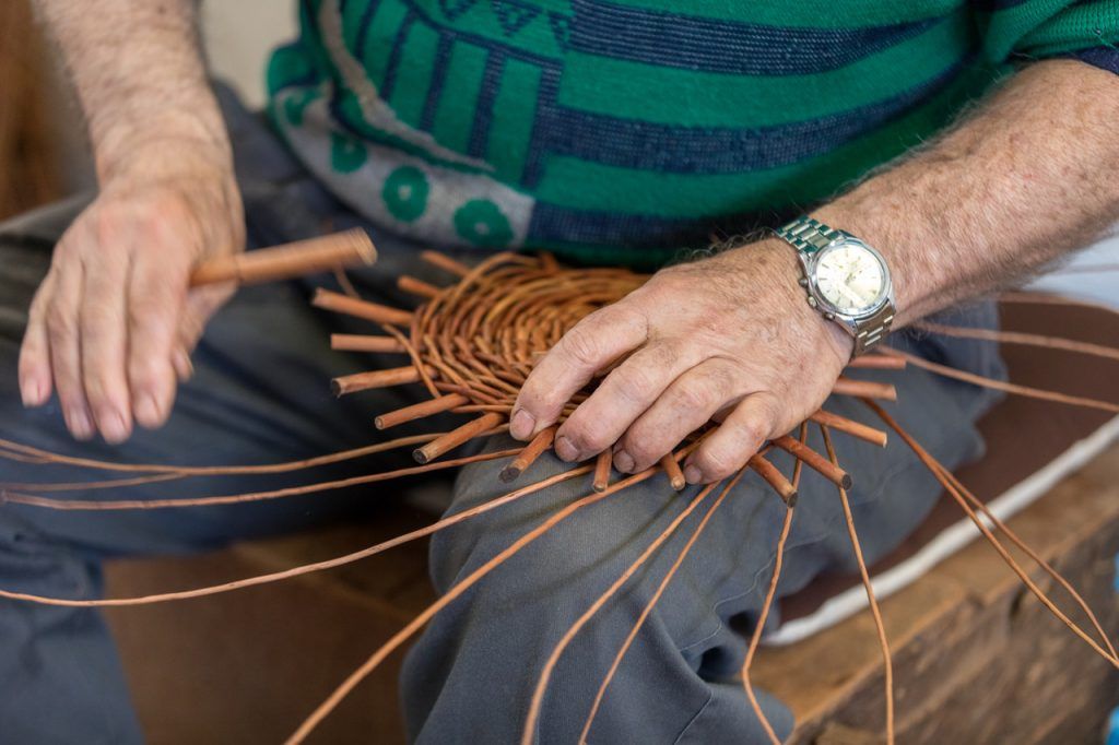 A basket weaver at work in the factory shop in Camacha on Madeira Island, Portugal