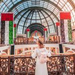 A young tourist walks through one of the largest shopping centers in Dubai – Emirates Mall.