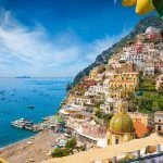 Aerial view of Positano with comfortable beach and blue sea on Amalfi Coast in Campania, Italy. Amalfi coast is popular travel and holyday destination in Europe. Ripe yellow lemons in foreground