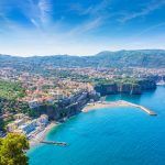Aerial view of cliff coastline Sorrento and Gulf of Naples, Italy. Ripe yellow lemons in foreground. In Sorrento lemons are used in production of limoncello