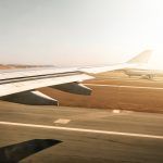 Aerial view out of airplane window while taking off from the runway of the airport