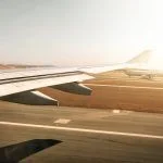 Aerial view out of airplane window while taking off from the runway of the airport
