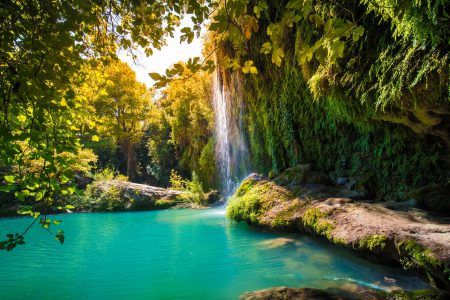 Majestic waterfall with a green pool. Waterfall view in sunny day. Kursunlu waterfalls, Antalya, Turkey
