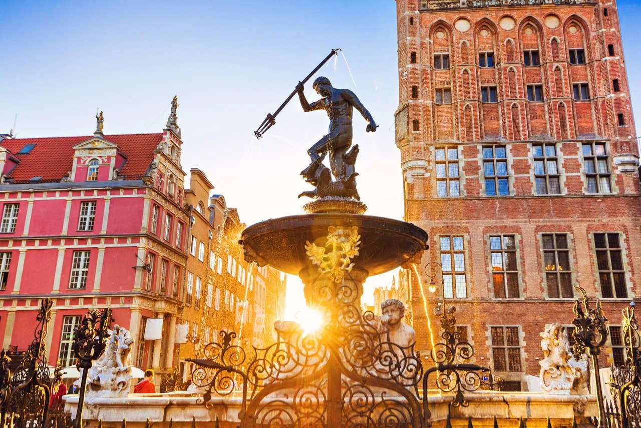 Poland, Gdansk, Famous Neptune fountain at sunset. Popular tourist attraction and travel destination in Europe