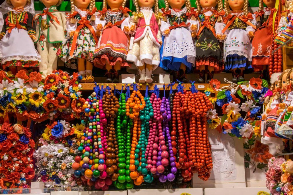 Souvenir shop in Krakow with handicrafts. Pictured dolls in traditional costumes, colorful beads and flowers.