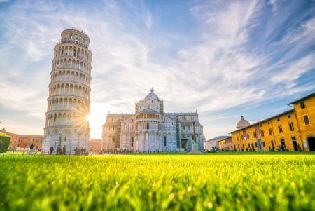 The Leaning Tower of Pisa, campanile, or freestanding bell tower, of the cathedral of the Italian city of Pisa. Blue sky.