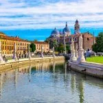 View of the canal with statues in Prato della Valle and the Basilica of Santa Giustina in Padua (Padua), Veneto, Italy