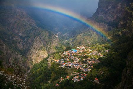 amazing view of a small cozy village Curral das Freiras with a rainbow above, Madeira, Portugal