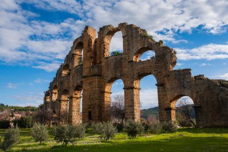 historical aspendos aqueduct siphon view with olive trees in antalya