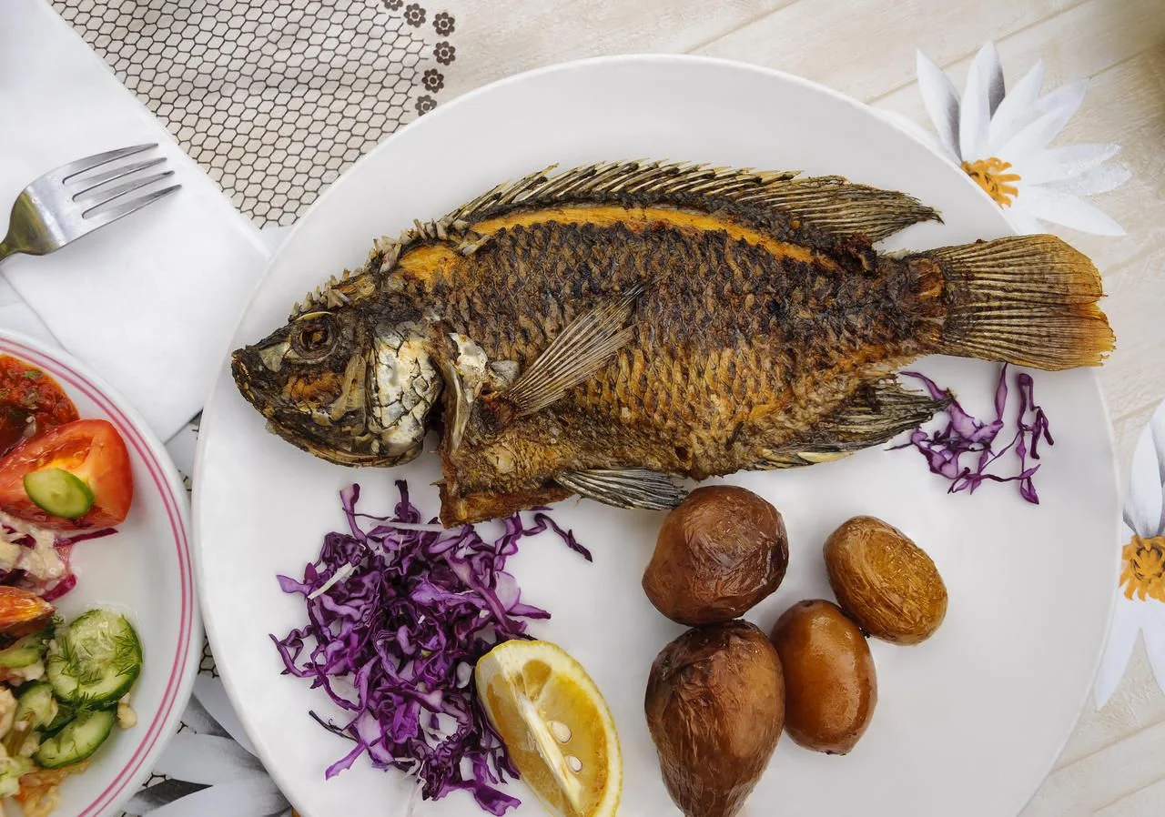 Fried tilapia fish from Tiberias Lake (the Sea of Galilee, Gennesaret Lake) in Israel. Tilapia is also called St. Peter’s fish