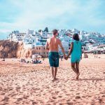 Happy Young couple walking at the beach of Albufeira Algarve Portugal