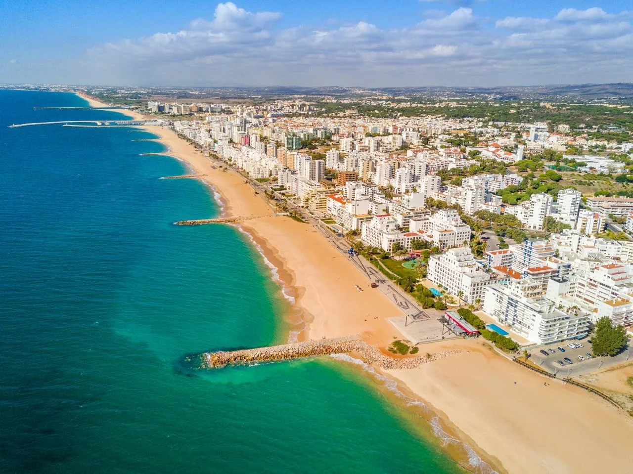 Wide sandy beach in touristic resorts of Quarteira and Vilamoura, Algarve, Portugal