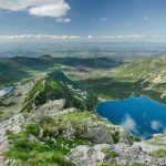 View of Gąsienicowa Valley (Dolina Gąsienicowa) with its numerous ponds from Mt Kościelec, with Zakopane in the background, Tatra Mountains, Poland