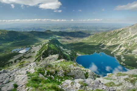 View of Gąsienicowa Valley (Dolina Gąsienicowa) with its numerous ponds from Mt Kościelec, with Zakopane in the background, Tatra Mountains, Poland